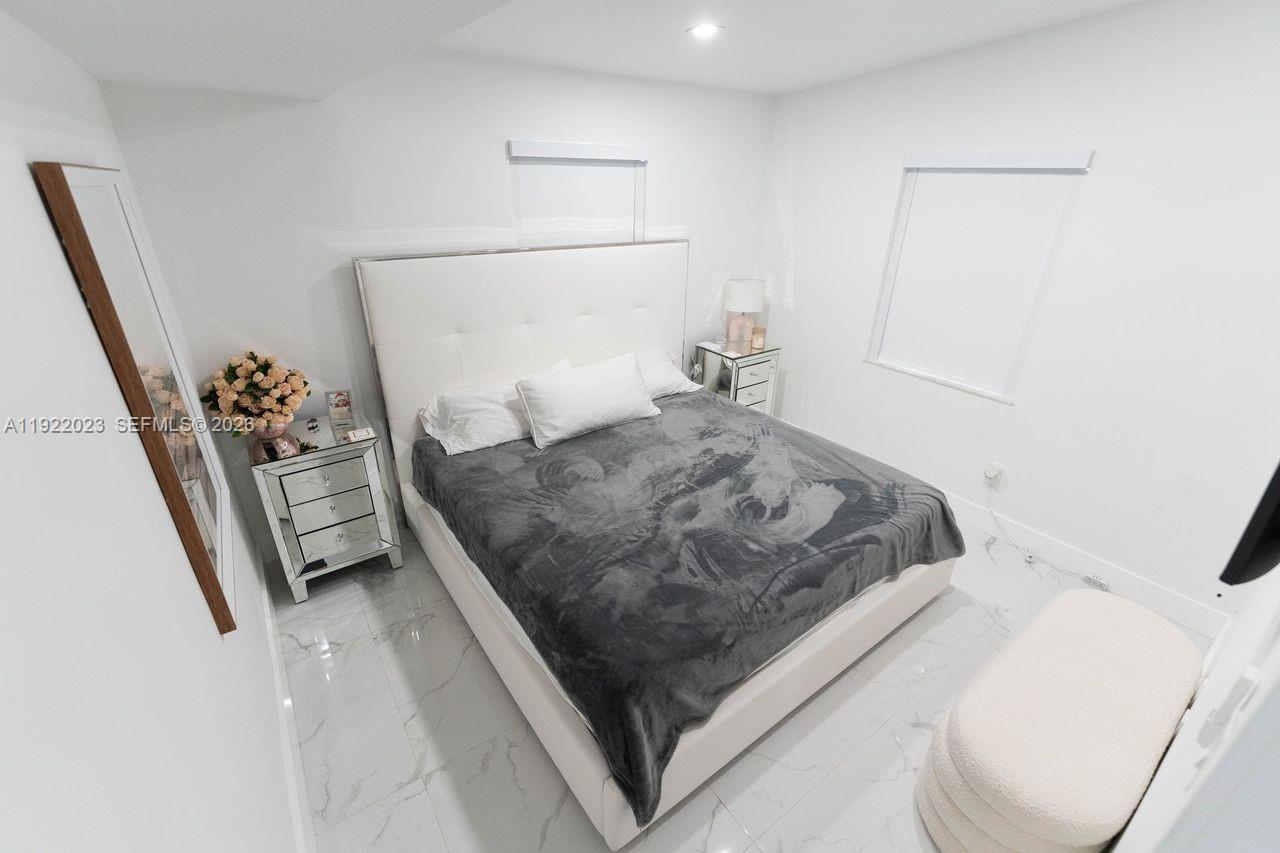 5200 Southwest 114th Court Miami, FL 33165 - Photo 20 of 36 a bedroom with a bed and a flat tv screen on a dresser