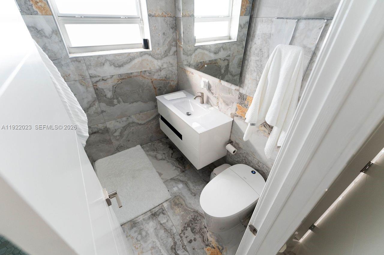 5200 Southwest 114th Court Miami, FL 33165 - Photo 22 of 36 a bathroom with a sink a toilet and tub