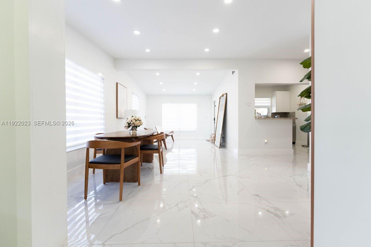 5200 Southwest 114th Court Miami, FL 33165 - Photo 31 of 36 a kitchen with a sink and a stove top oven with wooden floor