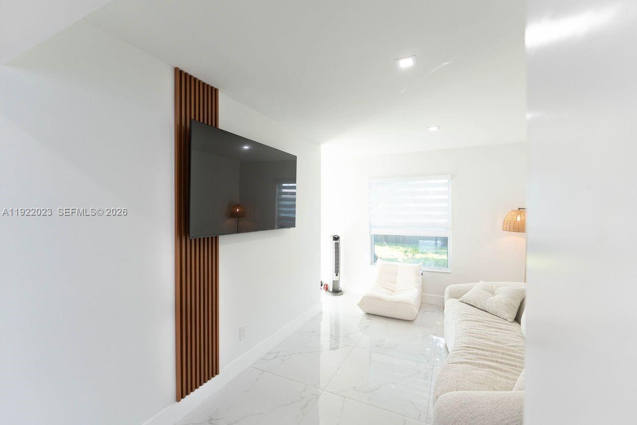 5200 Southwest 114th Court Miami, FL 33165 - Photo 33 of 36 a living room with furniture and a flat screen tv