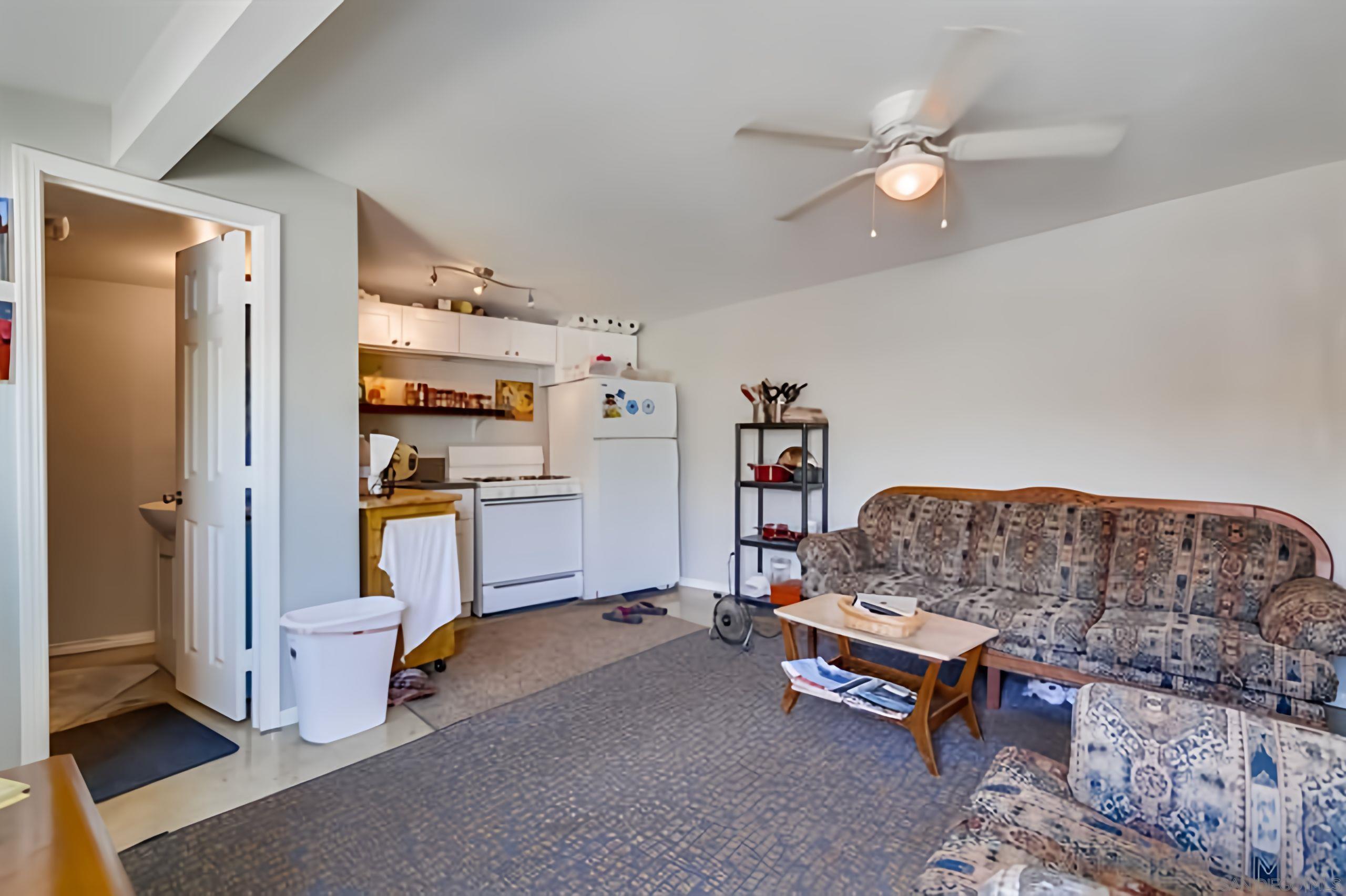 4667 35th Street San Diego, CA 92116 - Photo 12 of 29 a living room with furniture and a chandelier