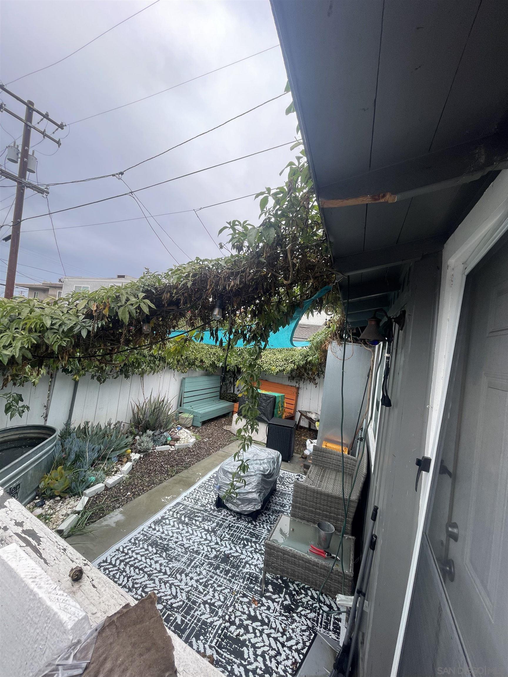4667 35th Street San Diego, CA 92116 - Photo 20 of 29 a backyard of a house with lots of green space and fountain
