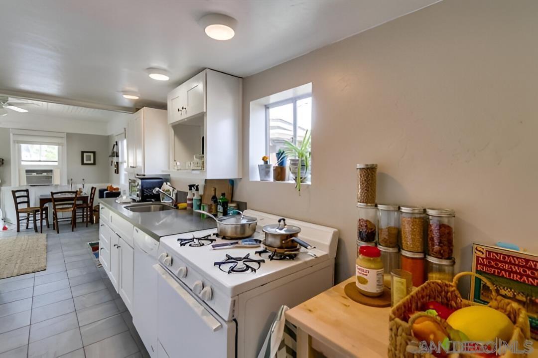 4667 35th Street San Diego, CA 92116 - Photo 24 of 29 a kitchen with a stove and a wooden floors