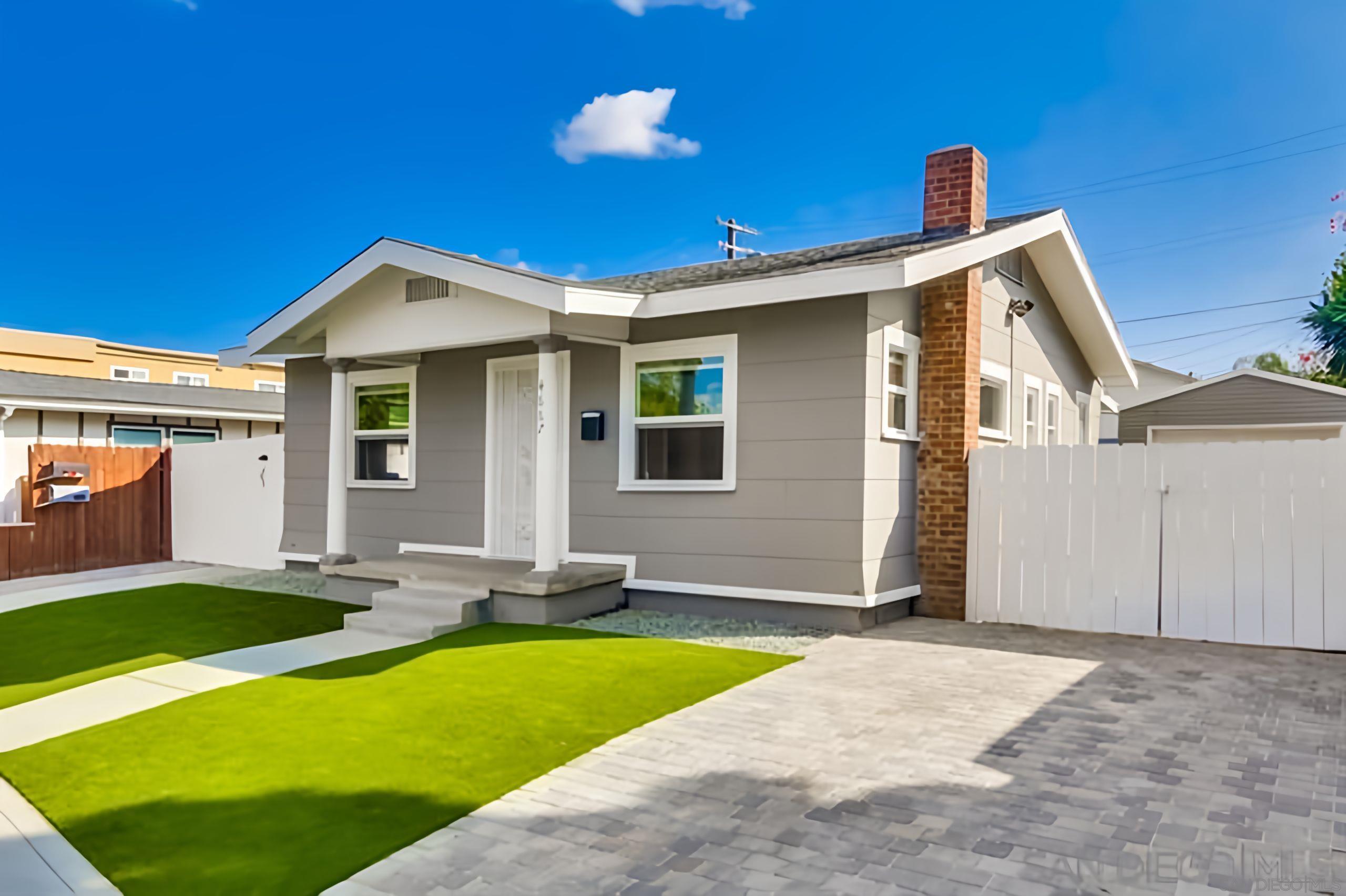 4667 35th Street San Diego, CA 92116 - Photo 4 of 29 a front view of a house with a yard