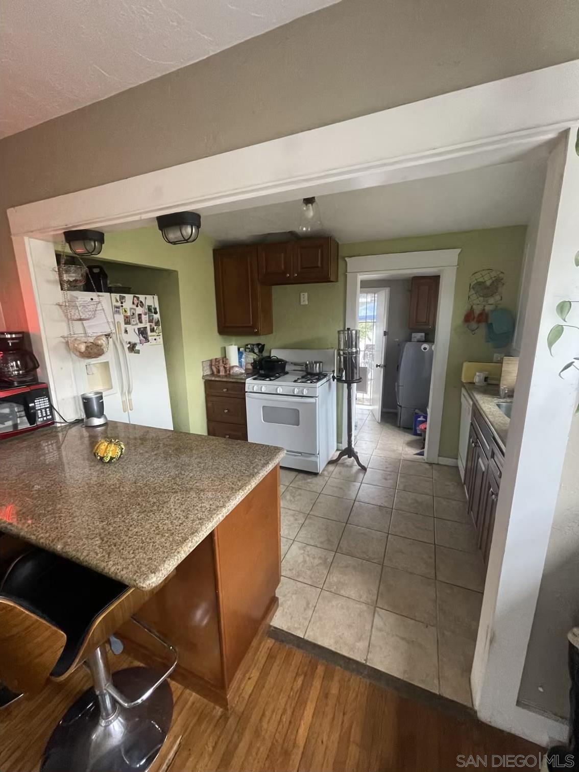 4667 35th Street San Diego, CA 92116 - Photo 7 of 29 a view of kitchen with furniture and wooden floor