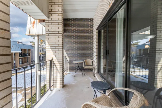 a balcony with furniture and a potted plant