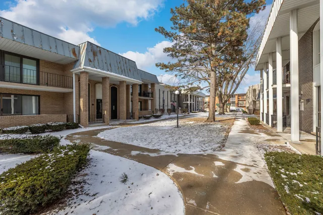 a view of a white house with a yard