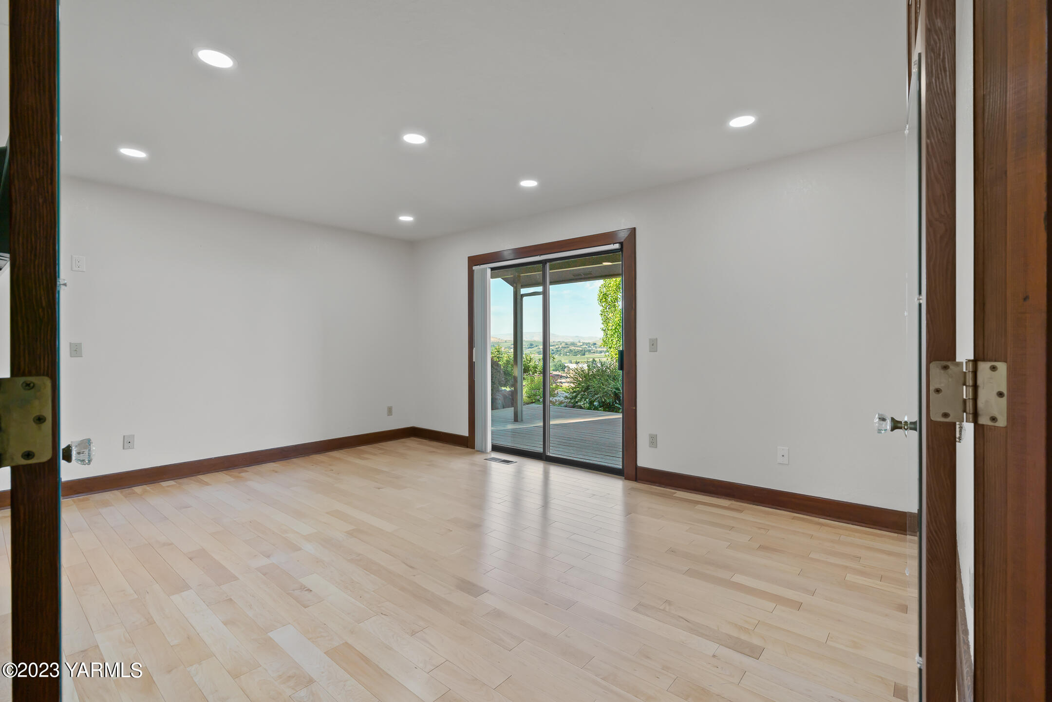 291 Orchard Street Yakima, WA 98908 - Photo 17 of 35 a view of an empty room with wooden floor and a window