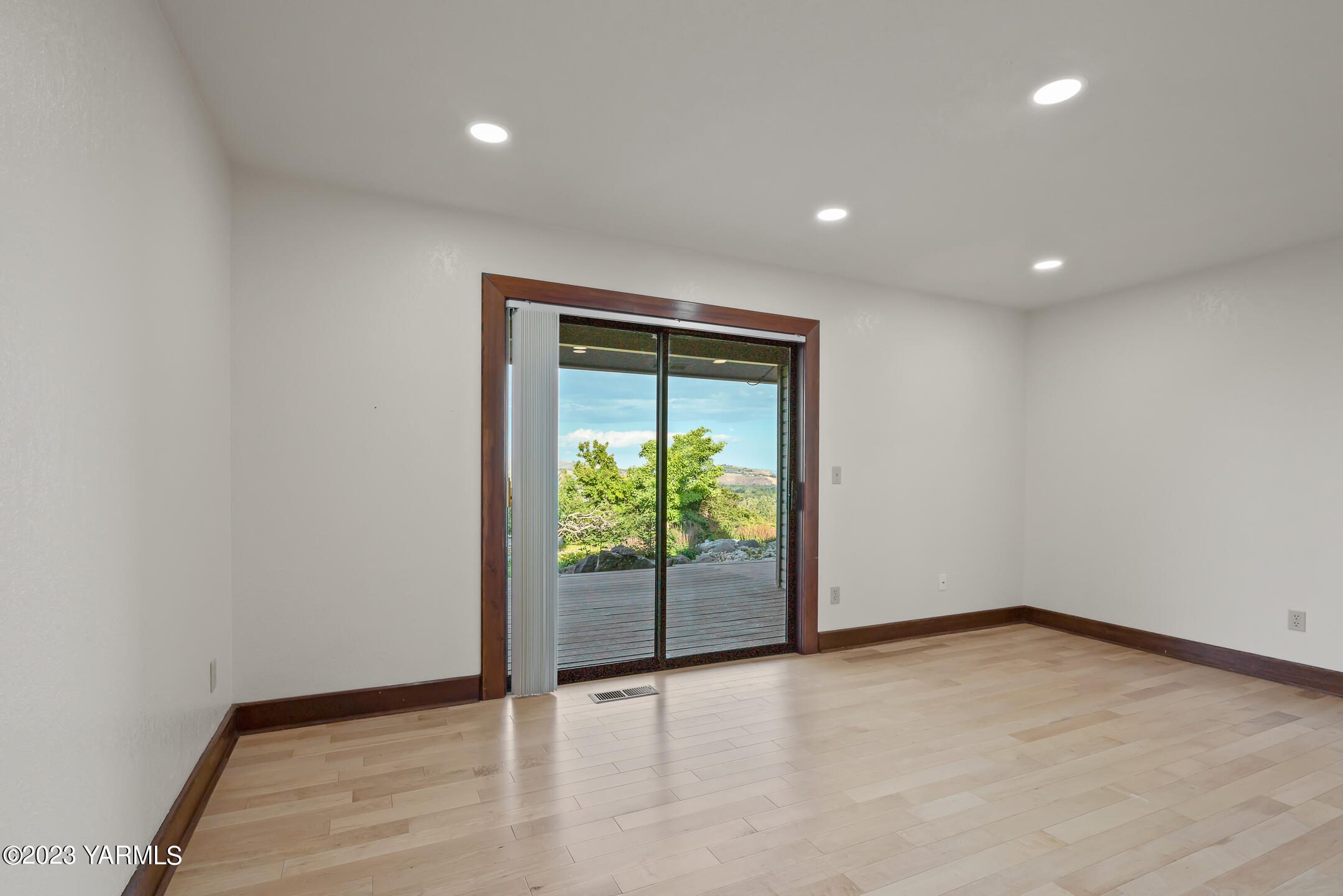 291 Orchard Street Yakima, WA 98908 - Photo 18 of 35 a view of an empty room with wooden floor and a window