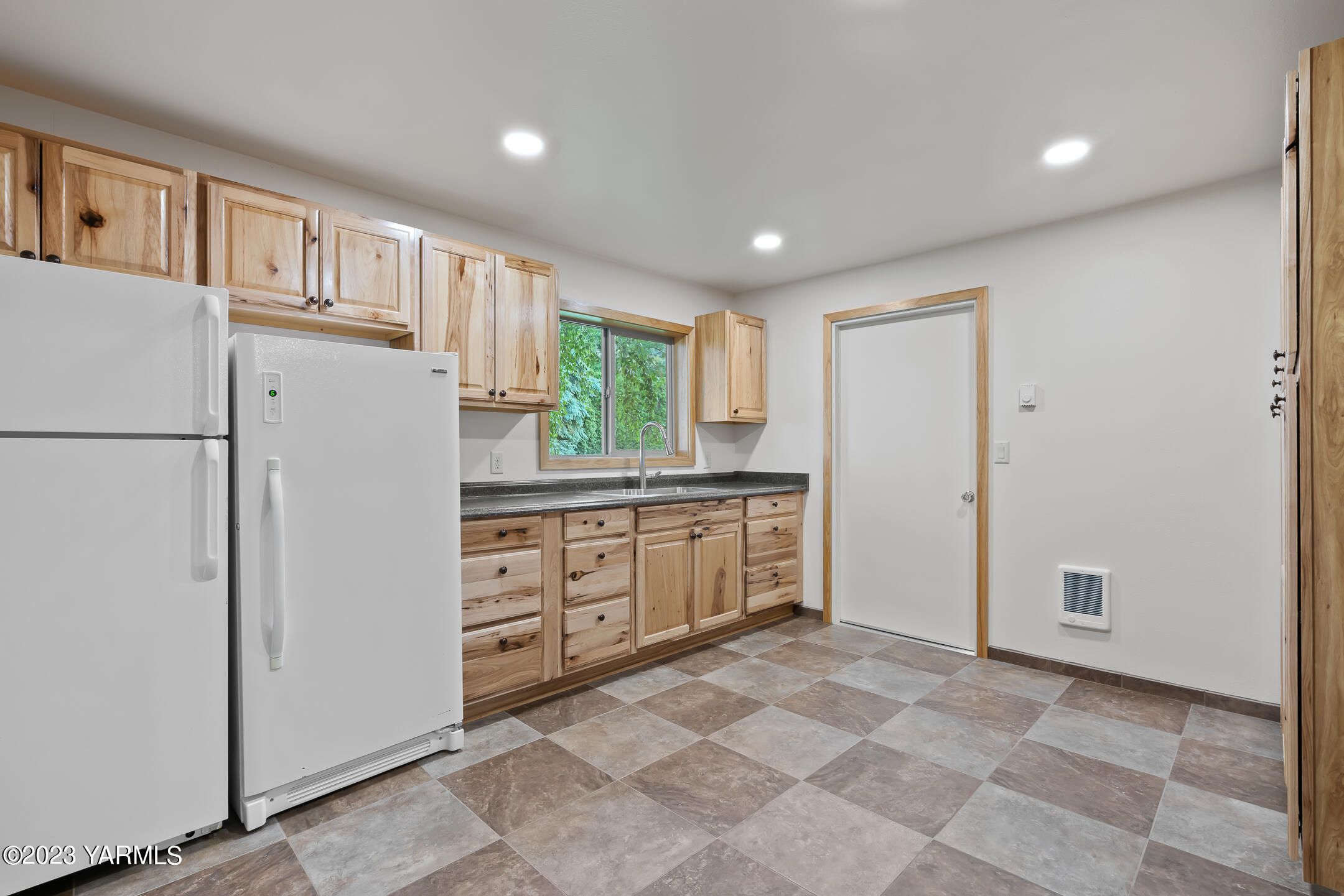 291 Orchard Street Yakima, WA 98908 - Photo 21 of 35 a kitchen with granite countertop cabinets and refrigerator