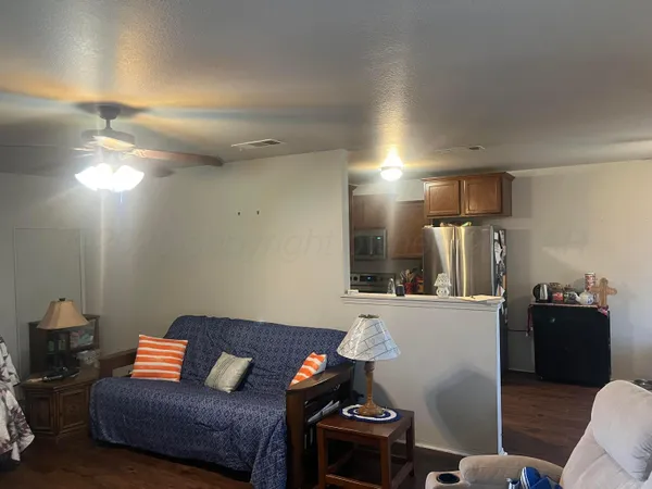 a living room with furniture and a lamp