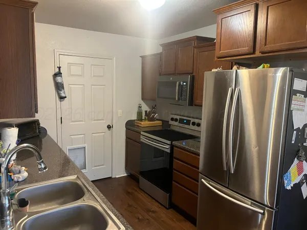 a kitchen with a refrigerator stove and cabinets