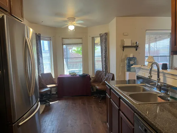 a kitchen with sink refrigerator and window