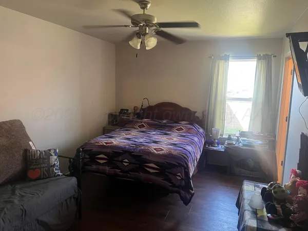 a bedroom with a bed dresser and a window