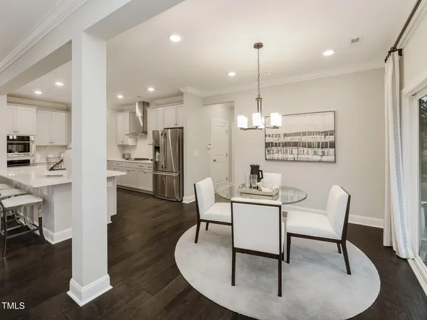 a dining room with furniture and a chandelier
