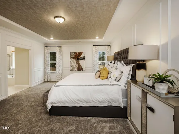 a bedroom with a bed and a lamp