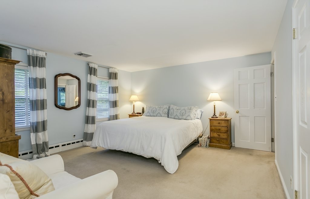 2 Wilson Road Concord, MA 01742 - Photo 14 of 19 a bedroom with a bed and cabinets