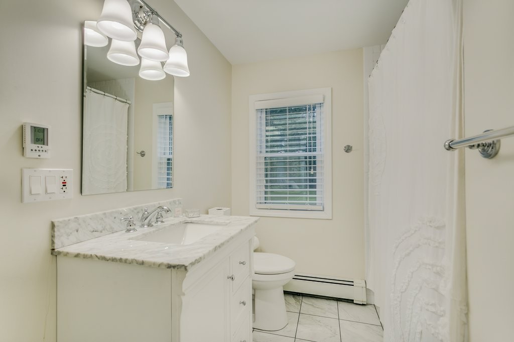 2 Wilson Road Concord, MA 01742 - Photo 19 of 19 a bathroom with a sink a toilet and a mirror