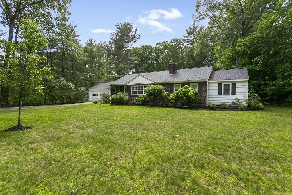 2 Wilson Road Concord, MA 01742 - Photo 2 of 19 a house with green field in front of it
