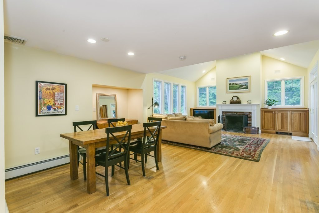 2 Wilson Road Concord, MA 01742 - Photo 6 of 19 a living room with furniture a fireplace and a table with wooden floor