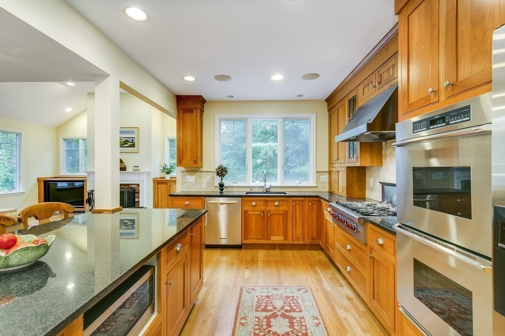 2 Wilson Road Concord, MA 01742 - Photo 7 of 19 a large kitchen with stainless steel appliances granite countertop a large stove top oven and cabinets