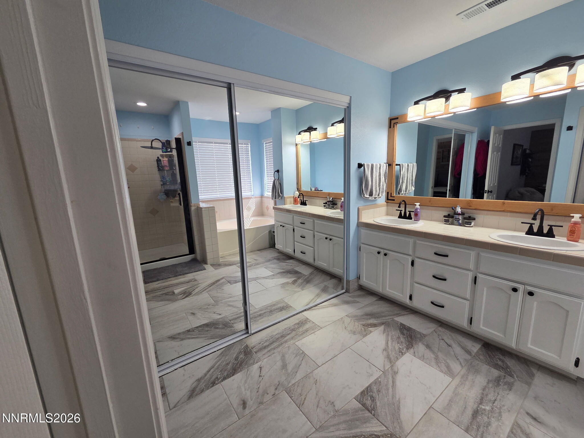 1383 Rambling Wind Drive Fallon, NV 89406 - Photo 13 of 15 a bathroom with a double vanity sink mirror and shower