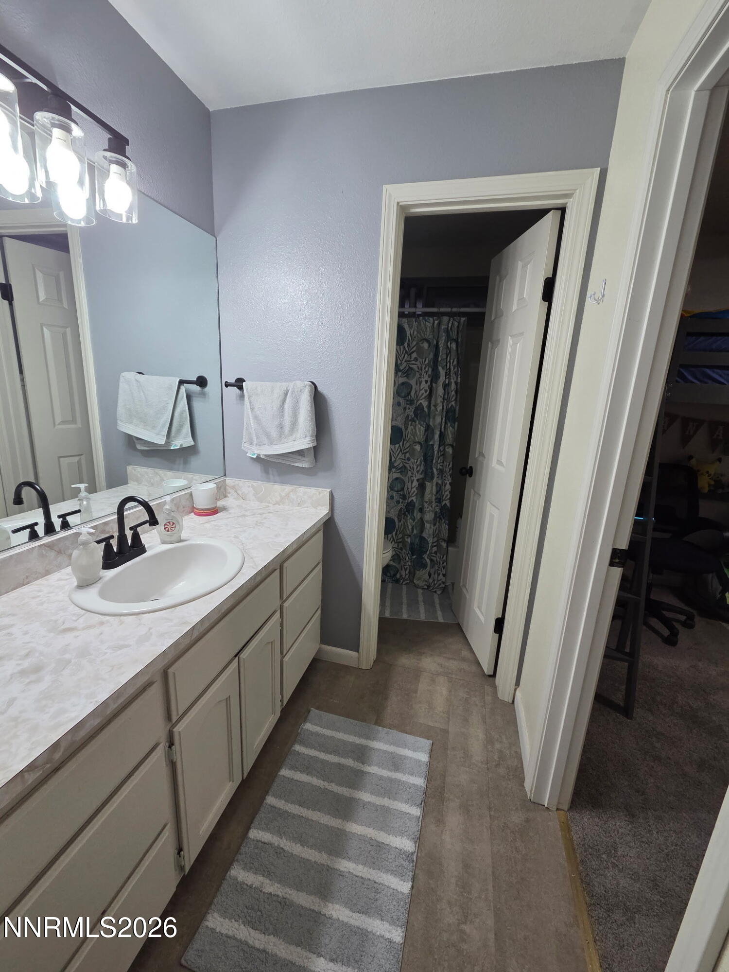 1383 Rambling Wind Drive Fallon, NV 89406 - Photo 15 of 15 a bathroom with a double vanity sink and mirror