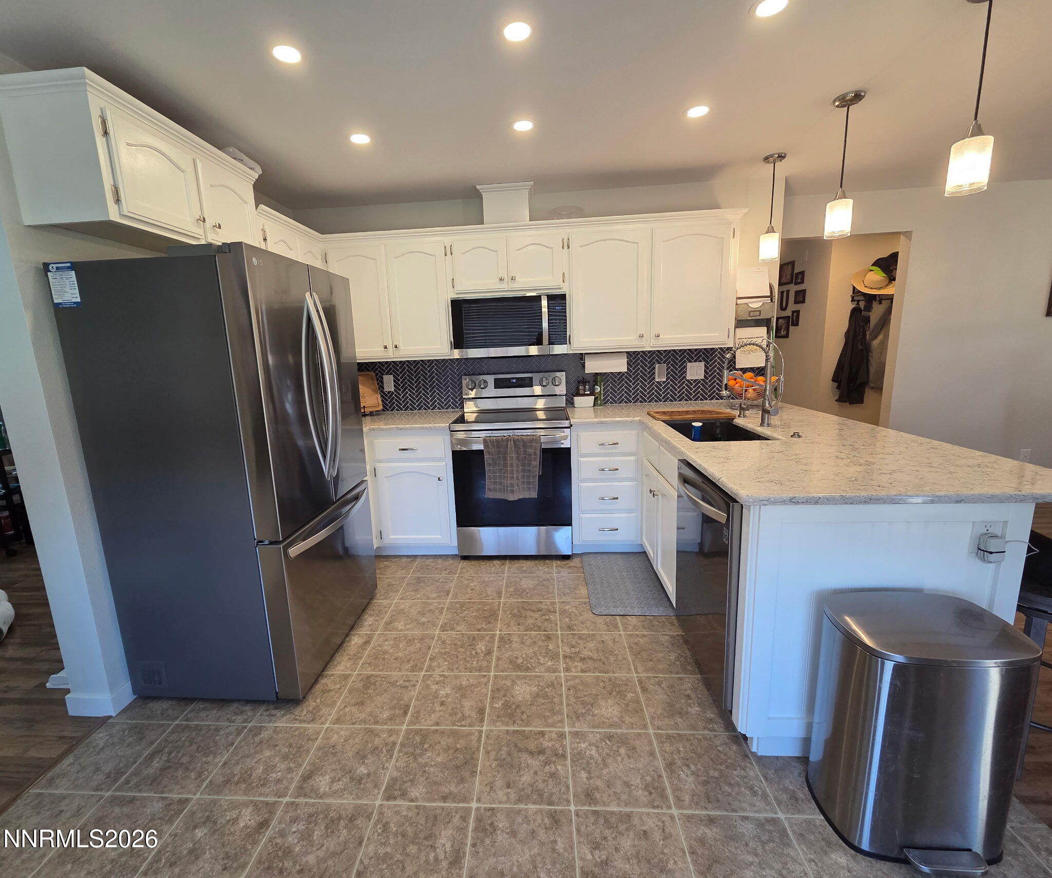 1383 Rambling Wind Drive Fallon, NV 89406 - Photo 2 of 15 a large kitchen with stainless steel appliances granite countertop a stove a sink a refrigerator and a microwave