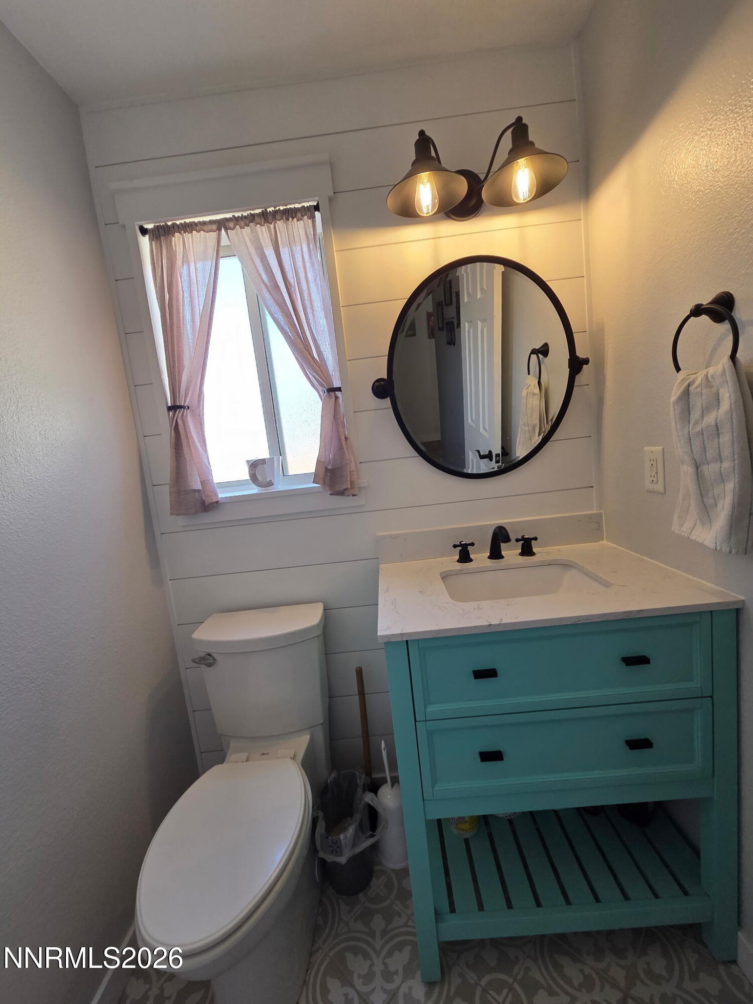 1383 Rambling Wind Drive Fallon, NV 89406 - Photo 3 of 15 a bathroom with a toilet sink and mirror