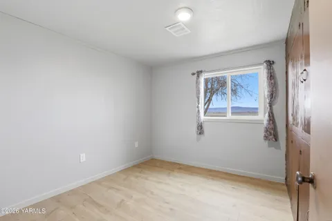 an empty room with windows and closet
