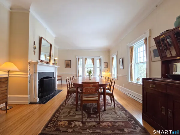 a view of a dining room with furniture window and wooden floor