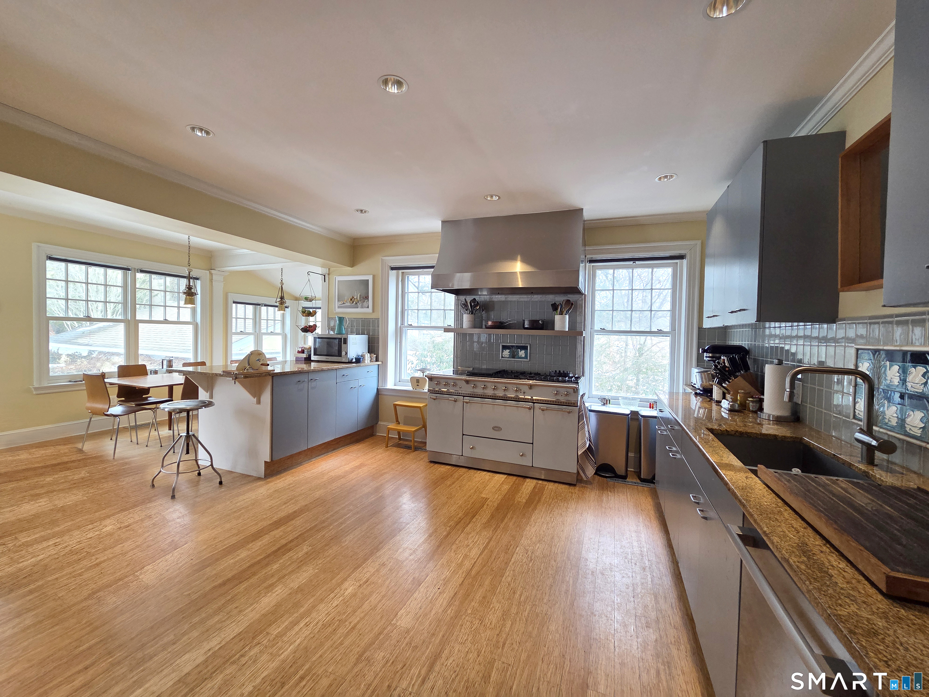 82 Edgehill Road New Haven, CT 06511 - Photo 12 of 29 a kitchen with stainless steel appliances wooden floors stove and sink