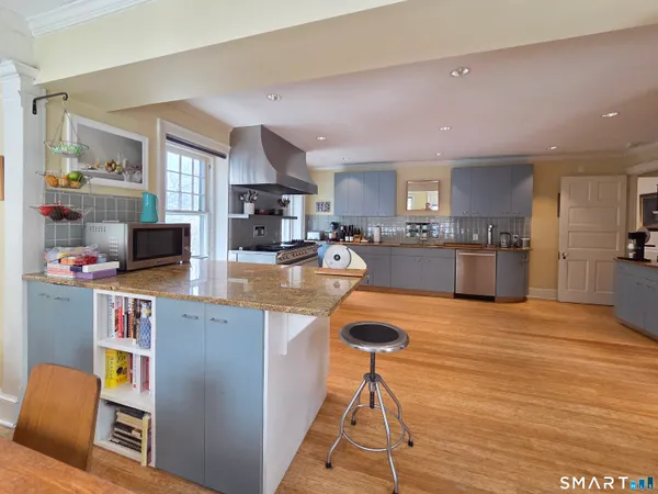 a kitchen with stainless steel appliances granite countertop a sink and cabinets