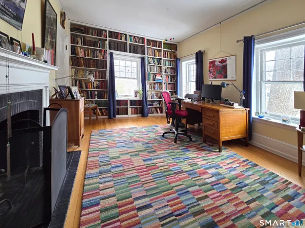 a bedroom with furniture and a fireplace