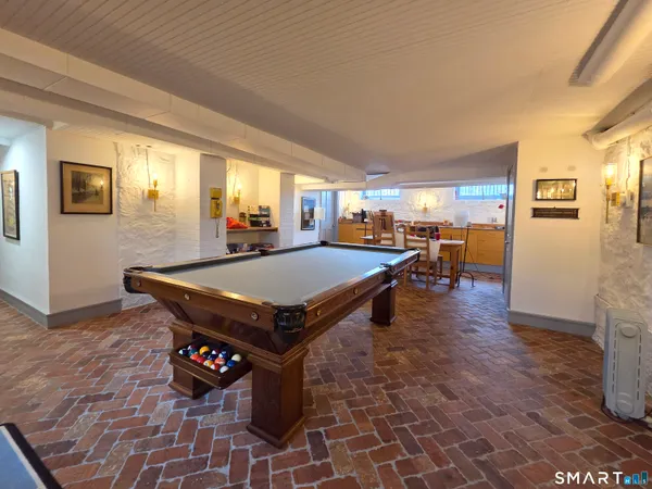 a room with pool table and windows
