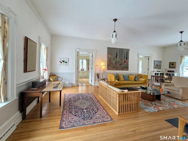 a living room with furniture and a wooden floor