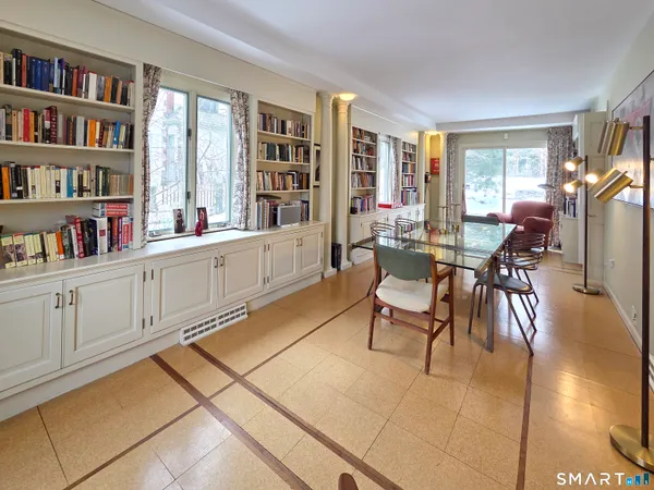 a living room with furniture and a book shelf