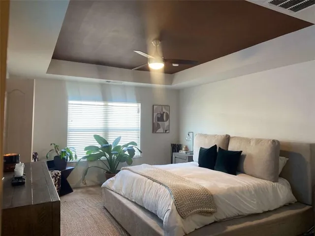 a bedroom with a bed and a potted plant
