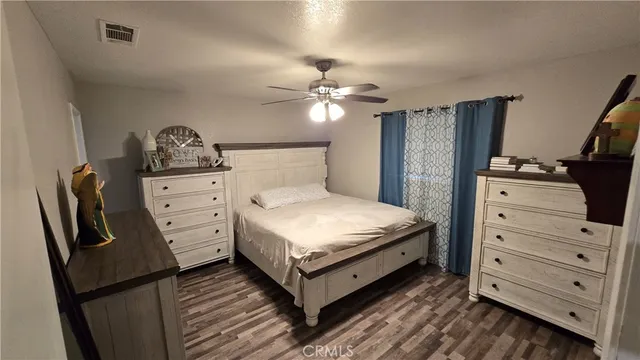 a bedroom with a bed and dresser