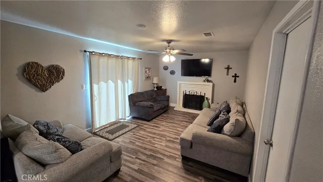 a bedroom with furniture or flat screen tv and a fireplace