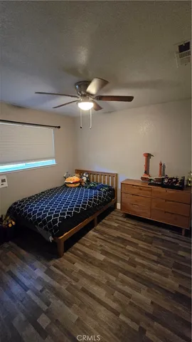 a bedroom with bed and wooden floor