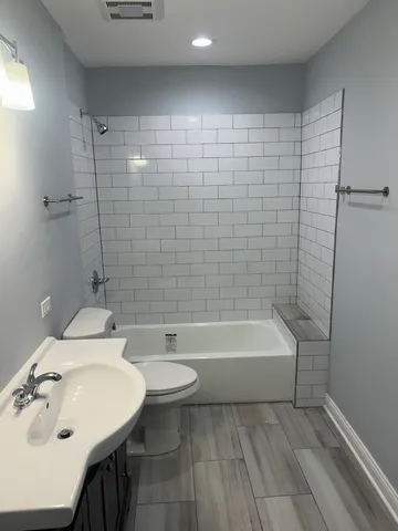 an empty room with wooden floor and closet