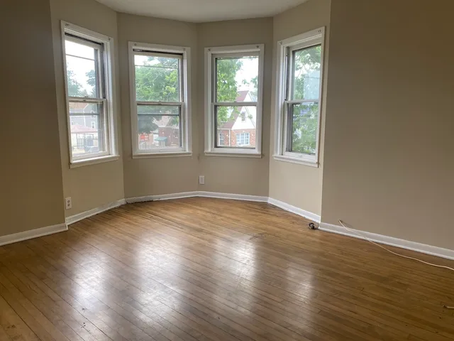 an empty room with wooden floor and closet