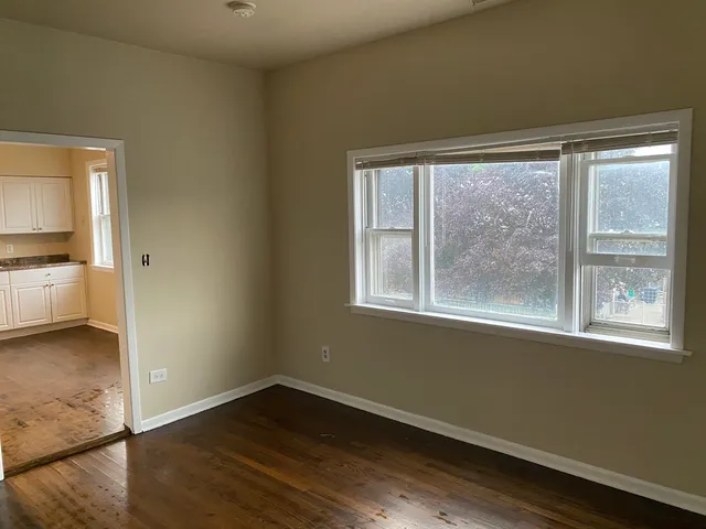 a kitchen with granite countertop stainless steel appliances a stove a sink a microwave a refrigerator and cabinets