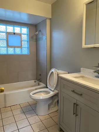 a living room with furniture ceiling fan and a rug