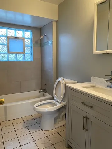 a living room with furniture ceiling fan and a rug
