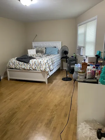 a view of a hallway with wooden floor and a livingroom