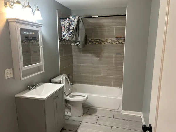 a bathroom with a sink toilet and shower