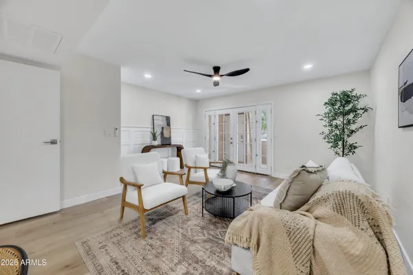 a living room with furniture and a potted plant