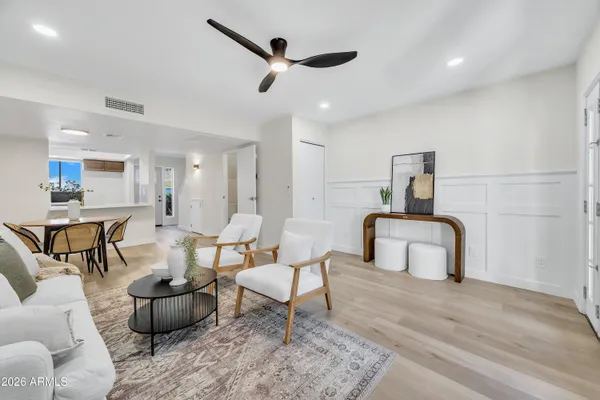 a living room with furniture and a wooden floor